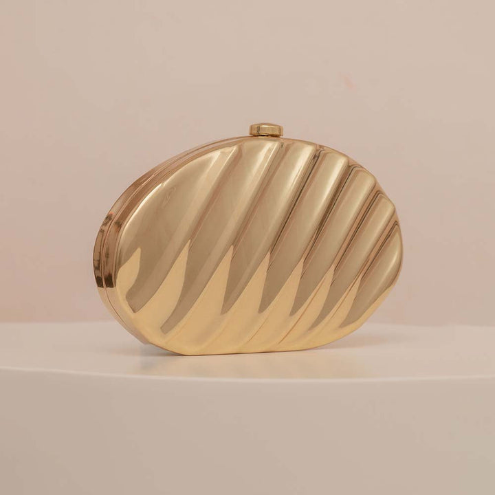 Textured metallic clutch with sculpted wave design – SHELL